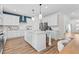 Bright kitchen with stainless steel appliances, white cabinets, and a large island with stone countertop at 2545 Dixon Pl, Lawrenceville, GA 30045