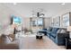 Inviting living room featuring a plush blue sectional, textured walls, and ample natural light at 2545 Dixon Pl, Lawrenceville, GA 30045