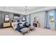Luxurious main bedroom featuring comfortable seating, stylish decor, and natural light at 2545 Dixon Pl, Lawrenceville, GA 30045