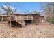 Backyard featuring mature trees, a wooden deck, and foliage at 5843 Foxfield Trl, Rex, GA 30273