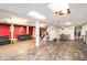 Finished basement with wood-look flooring, exposed ductwork, and black leather seating at 5843 Foxfield Trl, Rex, GA 30273