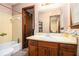 Bathroom with wooden vanity, tile flooring, bathtub, and an open doorway at 5843 Foxfield Trl, Rex, GA 30273