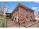 Back exterior view of a brick two-story home with fenced yard and screened in porch at 5843 Foxfield Trl, Rex, GA 30273