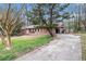 Lovely brick home with a long driveway and mature trees offers an inviting curb appeal at 5843 Foxfield Trl, Rex, GA 30273
