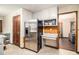 This kitchen features a stainless steel refrigerator and white cabinets at 5843 Foxfield Trl, Rex, GA 30273