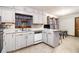 This kitchen features white cabinets, dishwasher, and an island at 5843 Foxfield Trl, Rex, GA 30273