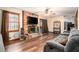 Inviting living room with a brick fireplace, hardwood floors, and a sliding glass door to a deck at 5843 Foxfield Trl, Rex, GA 30273