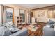 Bright living room featuring hardwood floors, a comfortable sofa, and large windows at 5843 Foxfield Trl, Rex, GA 30273