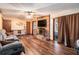 Cozy living room with hardwood floors, brick fireplace, and natural light offers a warm and inviting atmosphere at 5843 Foxfield Trl, Rex, GA 30273