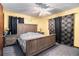 A spacious main bedroom with carpet, a ceiling fan, and a wooden headboard at 5843 Foxfield Trl, Rex, GA 30273