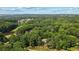 An aerial view of the property showing a house nestled amongst greenery and a golf course at 1323 Frey Lake Ct, Kennesaw, GA 30144