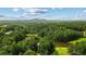 Scenic aerial view of community featuring lush greenery and mountain views at 1323 Frey Lake Ct, Kennesaw, GA 30144