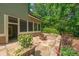 Picturesque backyard with a stone patio, cozy seating around the fire pit, and mature trees at 1323 Frey Lake Ct, Kennesaw, GA 30144