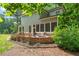 Beautiful backyard featuring a stone patio with a fire pit and lush landscaping at 1323 Frey Lake Ct, Kennesaw, GA 30144