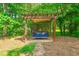 Backyard featuring a covered porch swing with colorful pillows at 1323 Frey Lake Ct, Kennesaw, GA 30144