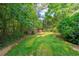 Spacious backyard with lush greenery and storage shed at 1323 Frey Lake Ct, Kennesaw, GA 30144
