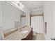 Bathroom with granite countertop, vanity, decorative mirrors, and walk in shower at 1323 Frey Lake Ct, Kennesaw, GA 30144
