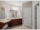 Bathroom featuring double sinks with a vanity, large mirrors, and tiled flooring at 1323 Frey Lake Ct, Kennesaw, GA 30144