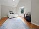 Bright bedroom with large window, vaulted ceiling, hardwood floors and a stylish rug at 1323 Frey Lake Ct, Kennesaw, GA 30144
