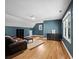 Large bonus room with hardwood floors, blue accent walls, and multiple windows at 1323 Frey Lake Ct, Kennesaw, GA 30144