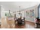 Open dining area with chandelier, hardwood floors, adjacent kitchen and large bright windows at 1323 Frey Lake Ct, Kennesaw, GA 30144