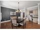 Dining area featuring hardwood floors, elegant chandelier, and built-in workspace at 1323 Frey Lake Ct, Kennesaw, GA 30144