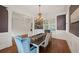 Dining room features a chandelier, hardwood floors, and access to living spaces at 1323 Frey Lake Ct, Kennesaw, GA 30144