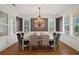 Bright dining room features a gorgeous chandelier, hardwood floors, and white wainscoting at 1323 Frey Lake Ct, Kennesaw, GA 30144