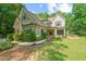 Charming exterior of a two-story home with a stone facade and well-manicured landscaping at 1323 Frey Lake Ct, Kennesaw, GA 30144
