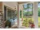 Inviting front porch with stone floor, a comfortable cushioned bench and lush landscaping at 1323 Frey Lake Ct, Kennesaw, GA 30144