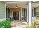 Charming front porch featuring stone accents, double doors, and comfortable seating areas at 1323 Frey Lake Ct, Kennesaw, GA 30144