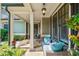 Relaxing front porch with stone flooring, wicker furniture, and views of the landscaped yard at 1323 Frey Lake Ct, Kennesaw, GA 30144