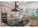 Modern kitchen with stainless appliances, center island, and granite countertops at 1323 Frey Lake Ct, Kennesaw, GA 30144