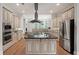 Open kitchen with island, stainless steel appliances, and granite countertops at 1323 Frey Lake Ct, Kennesaw, GA 30144