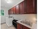 Well-equipped laundry room with ample counter space, storage cabinets, and modern appliances at 1323 Frey Lake Ct, Kennesaw, GA 30144