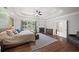 Well-lit main bedroom featuring a fireplace, hardwood floors and a ceiling fan at 1323 Frey Lake Ct, Kennesaw, GA 30144