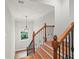 Staircase featuring hardwood stairs, wrought iron railings and natural light at 1323 Frey Lake Ct, Kennesaw, GA 30144