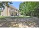 Large backyard features a covered patio ideal for outdoor entertainment at 1611 Hillside Bend Xing, Lawrenceville, GA 30043