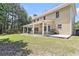 Spacious backyard showcasing an outdoor patio with seating and lush greenery at 1611 Hillside Bend Xing, Lawrenceville, GA 30043