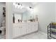 Bathroom featuring double vanity sinks with white cabinets, marble floors, and modern fixtures at 1611 Hillside Bend Xing, Lawrenceville, GA 30043
