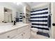Bathroom featuring blue and white decor, a shower curtain, and white cabinets at 1611 Hillside Bend Xing, Lawrenceville, GA 30043