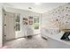 Bedroom with an abundance of natural light, butterfly decor, and a crib at 1611 Hillside Bend Xing, Lawrenceville, GA 30043