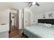 Cozy bedroom featuring stylish decor, ceiling fan and wood-look flooring at 1611 Hillside Bend Xing, Lawrenceville, GA 30043