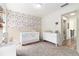 Bedroom with an abundance of natural light, butterfly decor, and a crib at 1611 Hillside Bend Xing, Lawrenceville, GA 30043