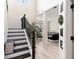 Bright foyer with staircase, light wood floors, and high ceilings leading into the living area at 1611 Hillside Bend Xing, Lawrenceville, GA 30043