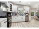 Bright kitchen featuring stainless steel appliances and gray backsplash at 1611 Hillside Bend Xing, Lawrenceville, GA 30043