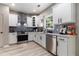 A well-equipped kitchen featuring white cabinets and stainless steel appliances at 1611 Hillside Bend Xing, Lawrenceville, GA 30043