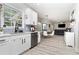 Bright kitchen open to dining area with sleek stainless steel dishwasher at 1611 Hillside Bend Xing, Lawrenceville, GA 30043