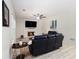 Cozy living room with a fireplace, ceiling fan, and comfortable seating at 1611 Hillside Bend Xing, Lawrenceville, GA 30043