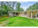 Green backyard featuring a covered patio and screened in porch at 3332 Saint John Dr, East Point, GA 30344